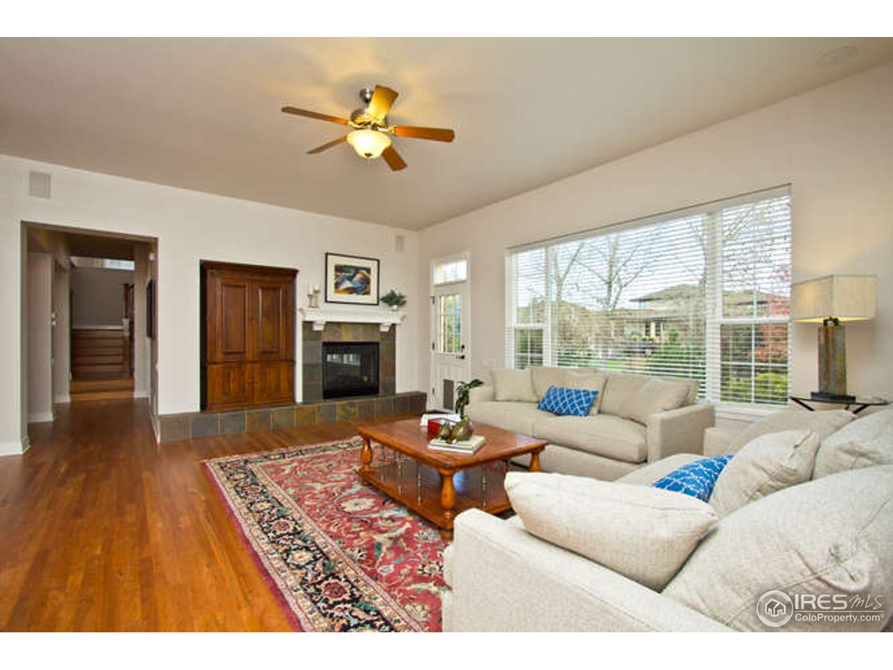3460 Rookery Road Fort Collins, CO 80528 - Photo 11 of 23 a living room with furniture fireplace and a large window