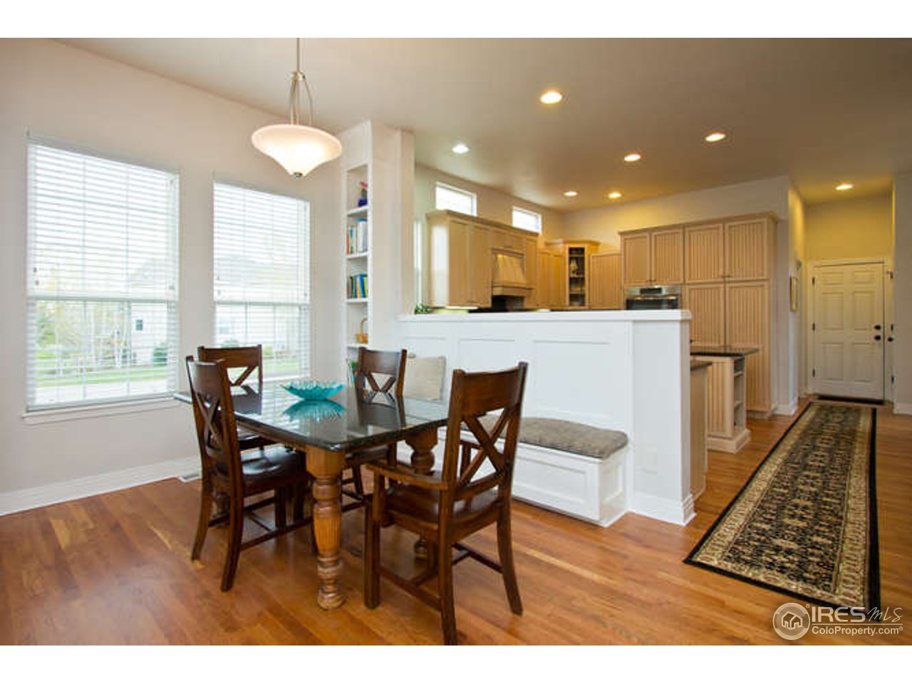 3460 Rookery Road Fort Collins, CO 80528 - Photo 13 of 23 a view of a dining room with furniture and wooden floor