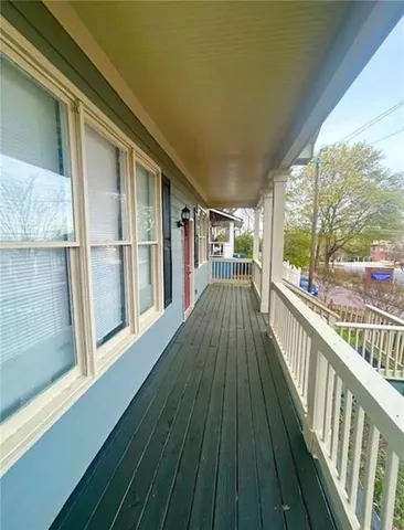 a view of a balcony with wooden floor