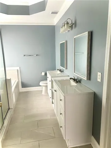 a bathroom with a sink a toilet a mirror and vanity