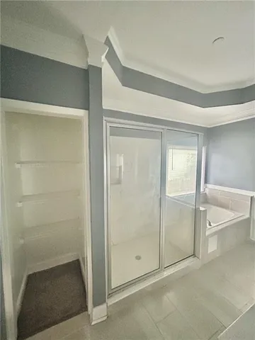 a bathroom with a shower and a glass door