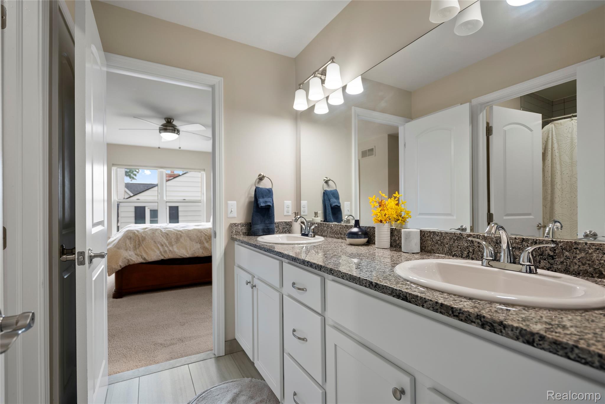 524 Ludlow Avenue Rochester, MI 48307 - Photo 19 of 36 Bathroom featuring double vanity, a ceiling fan, light tile patterned floors, and connected bathroom