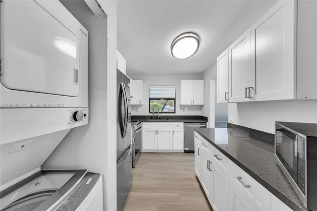 a kitchen with lot of cabinets and appliances