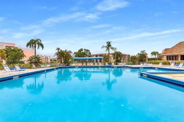 a view of swimming pool with outdoor seating and yard