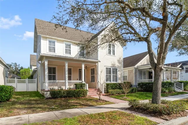 a view of a house with a tree in front of it