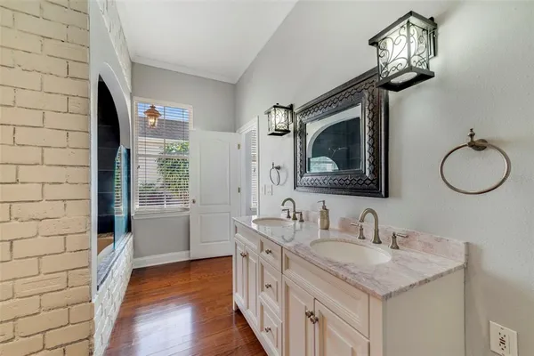 a bathroom with a double vanity sink and a mirror