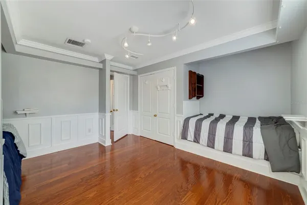 a spacious bedroom with a bed and a window