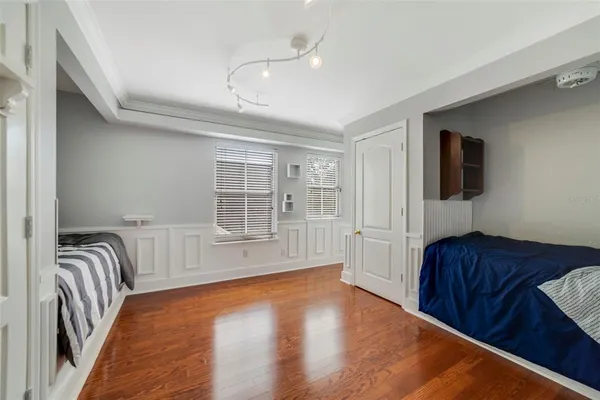 a bedroom with furniture and wooden floor