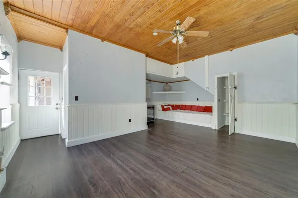 a view of empty room with wooden floor and fireplace