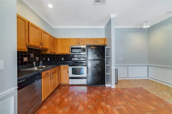 a view of a kitchen with a sink and a refrigerator