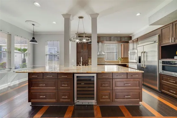 a kitchen with stainless steel appliances granite countertop a sink and wooden cabinets