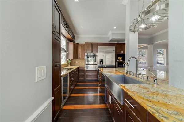 a view of a kitchen with kitchen island granite countertop a large counter top and stainless steel appliances