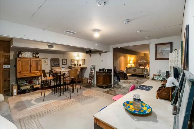 a view of a dining room with furniture and a flat screen tv