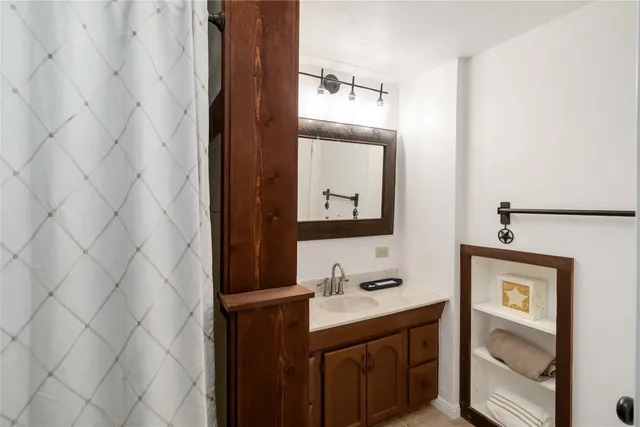 a bathroom with a sink vanity and a mirror