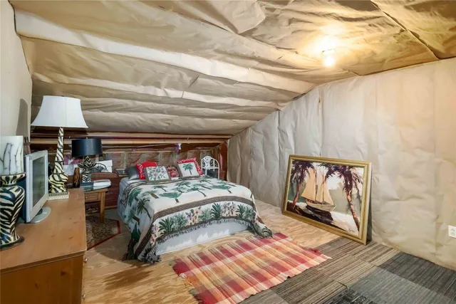 a bedroom with a bed dresser and a window