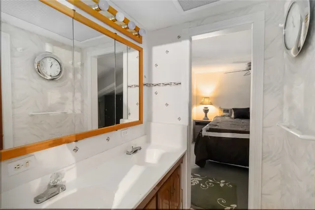 a bathroom with a painting on the wall and shower