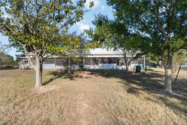 a view of a house with a yard and sitting area