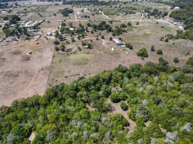 an aerial view of a houses with a yard
