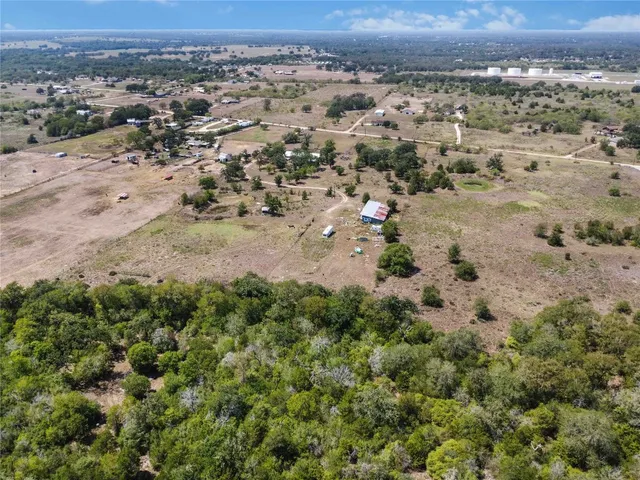 an aerial view of a house with yard and outdoor seating