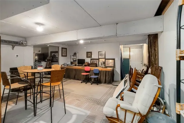 a living room with furniture a kitchen view and a dining table