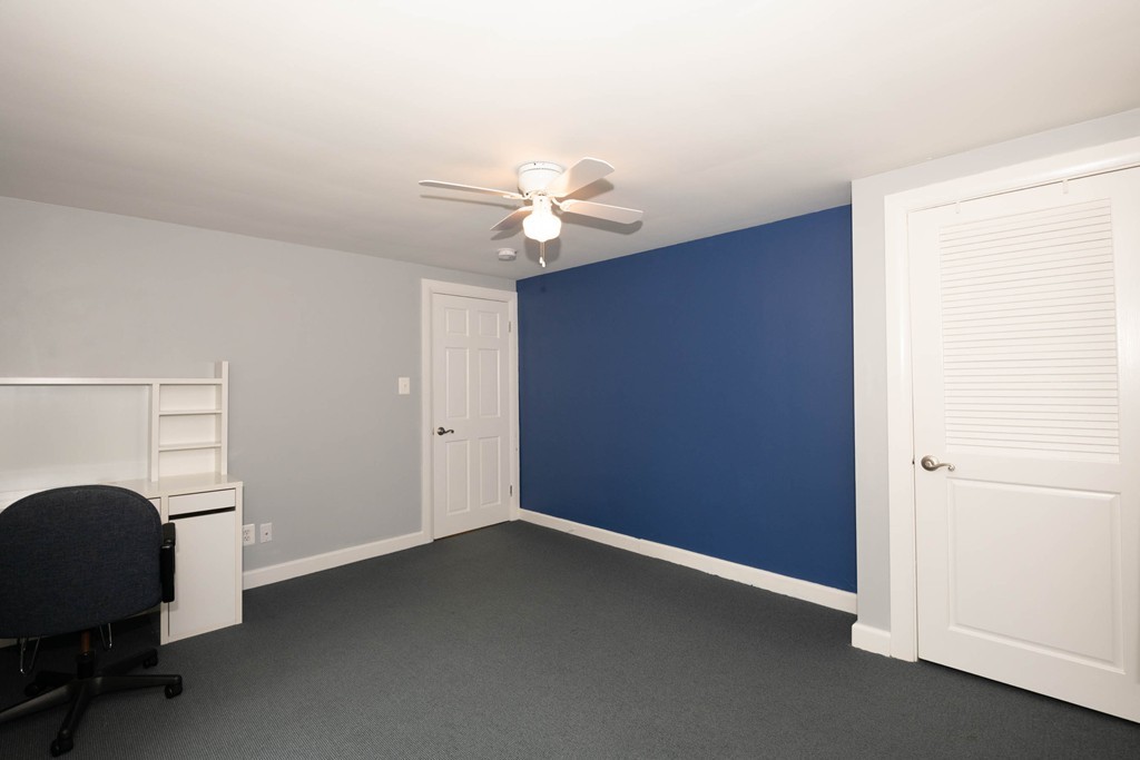 27 Margaret Road Hamilton, MA 01982 - Photo 12 of 30 an empty room with windows and fan