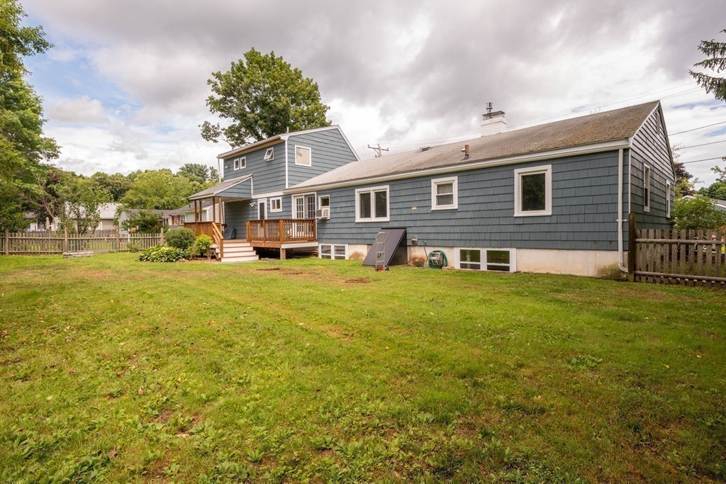 27 Margaret Road Hamilton, MA 01982 - Photo 29 of 30 a front view of a house with a yard table and chairs