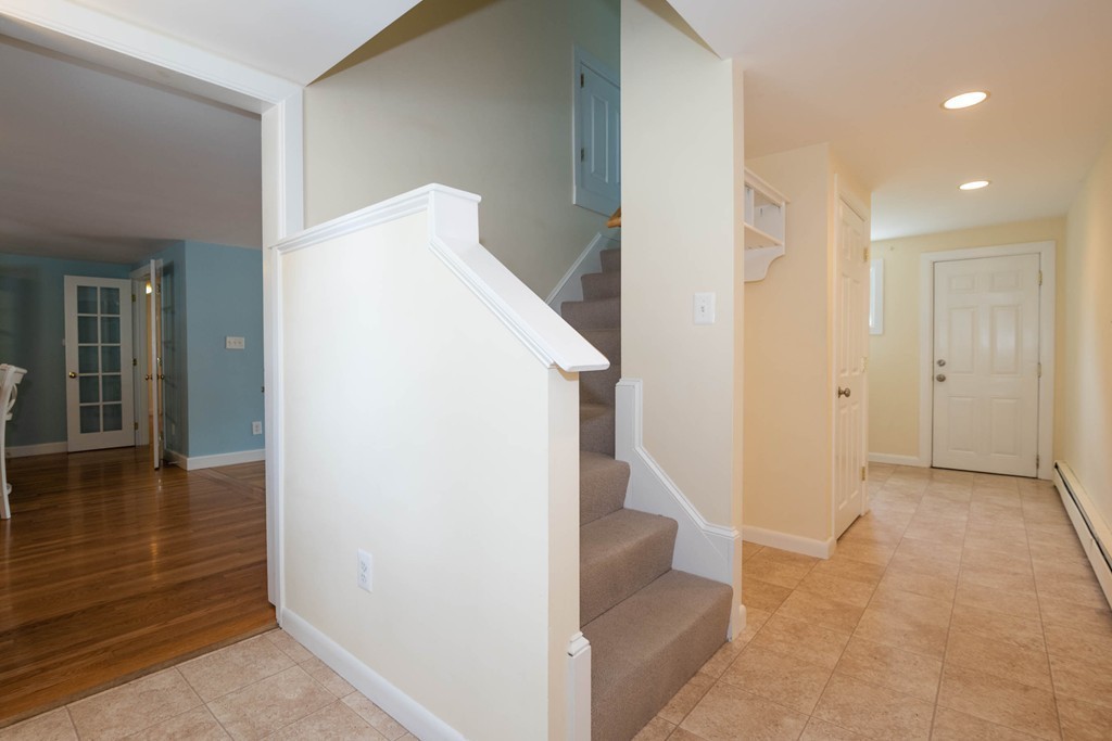 27 Margaret Road Hamilton, MA 01982 - Photo 3 of 30 a view of a hallway with wooden floor and staircase