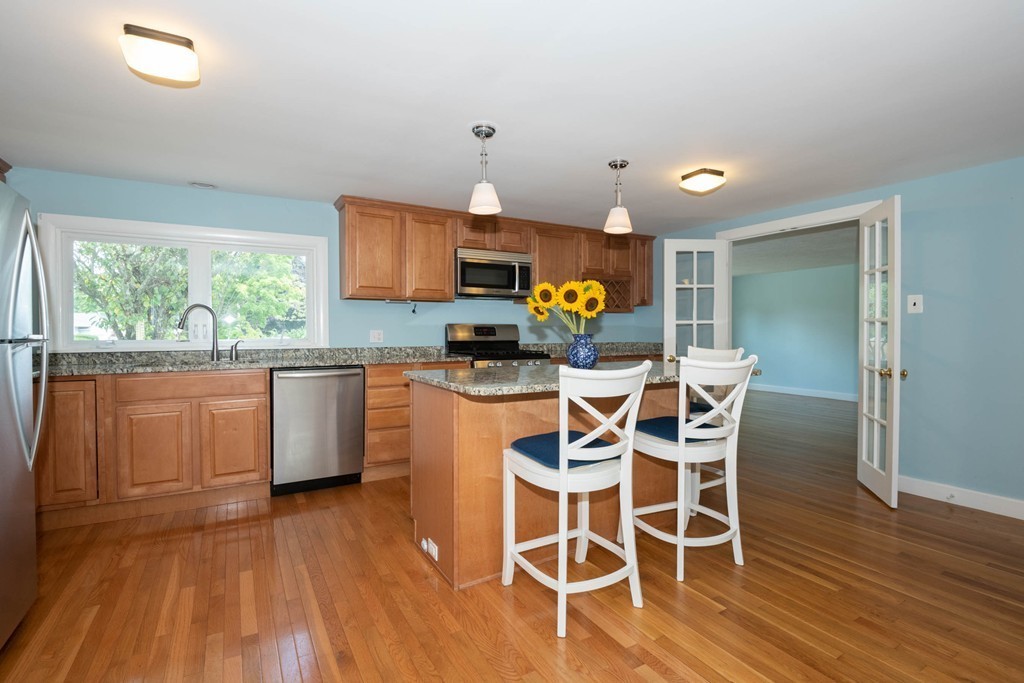27 Margaret Road Hamilton, MA 01982 - Photo 4 of 30 a kitchen with wooden floors and furniture