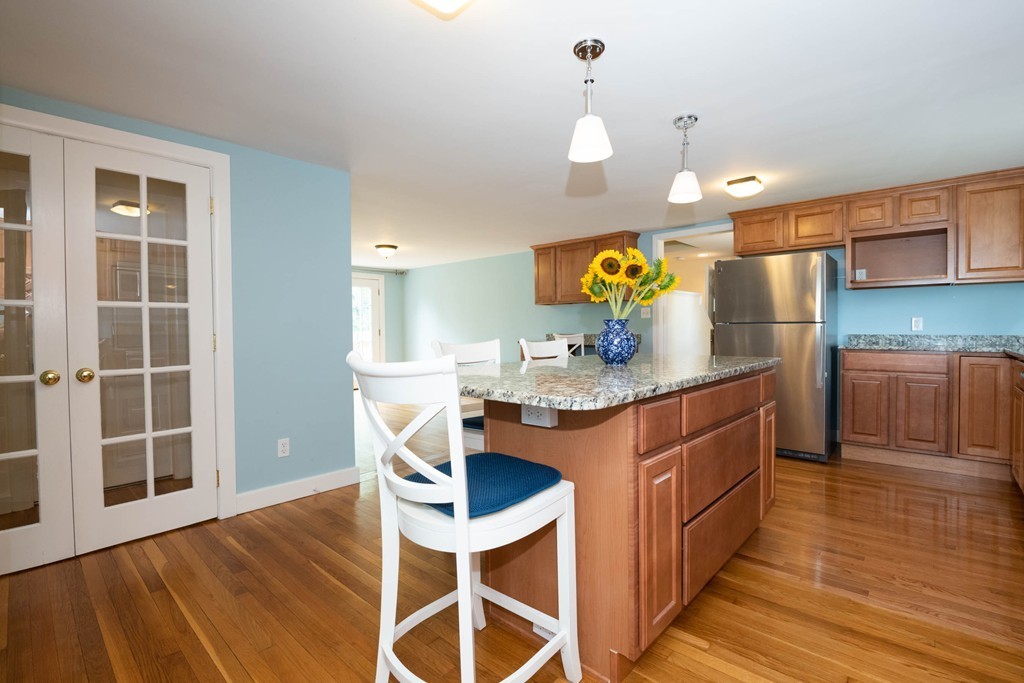 27 Margaret Road Hamilton, MA 01982 - Photo 6 of 30 a kitchen with stainless steel appliances granite countertop a sink cabinets and wooden floor