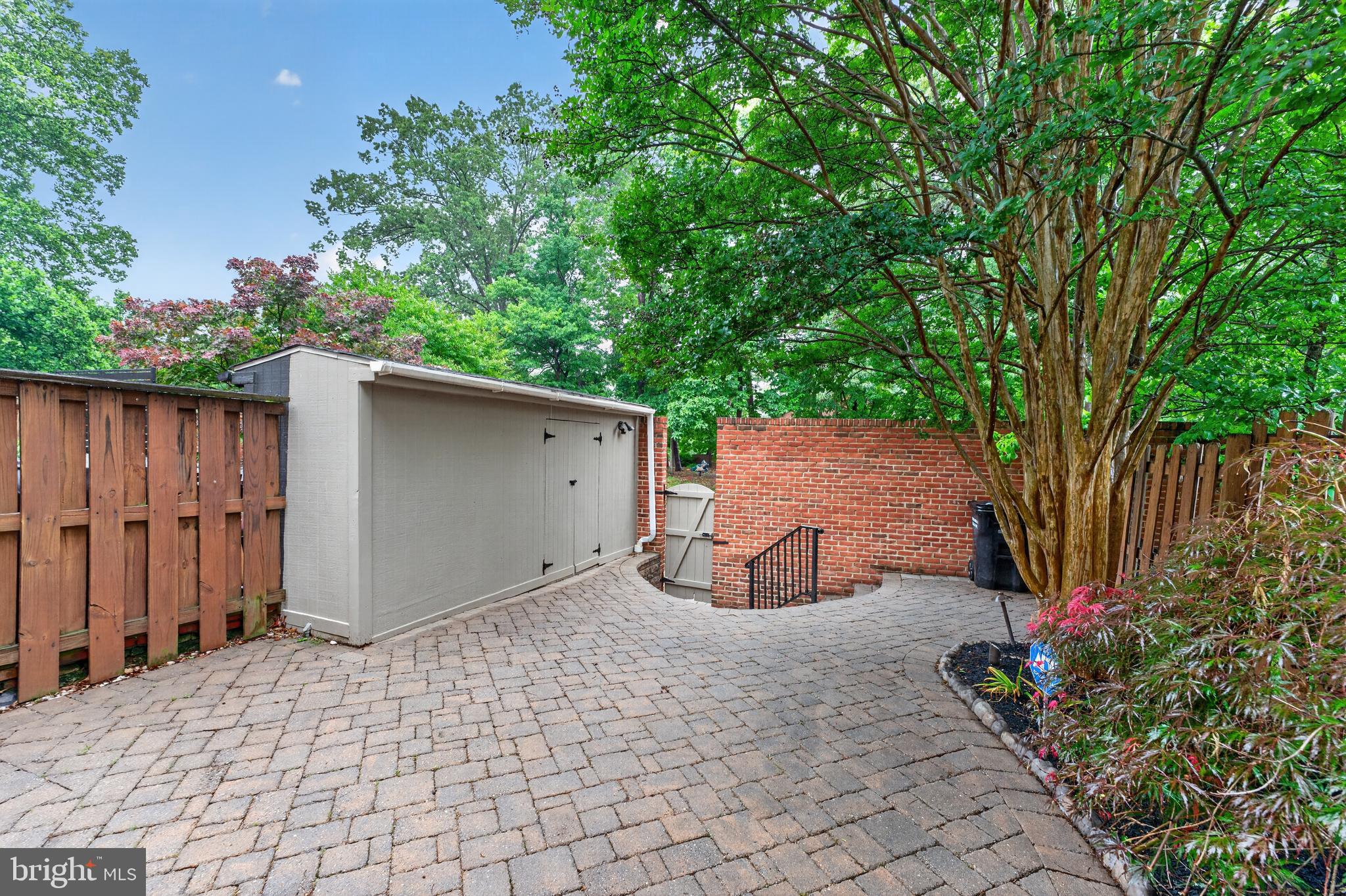 8139 Carrleigh Parkway Springfield, VA 22152 - Photo 13 of 27 a backyard of a house with lots of green space and wooden fence