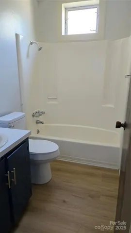 a bathroom with a toilet a sink and bathtub