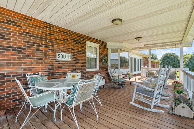 a swimming pool with outdoor seating and yard