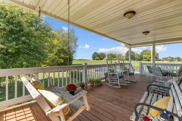 a view of a house with swimming pool and sitting area