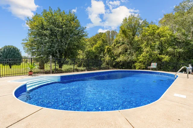 a living room with furniture fireplace and a large window