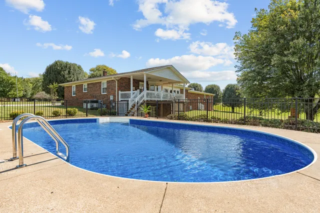 a living room with furniture a fireplace and large windows