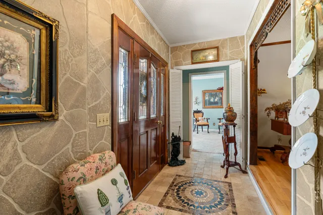 a living room with furniture a chandelier and a large window