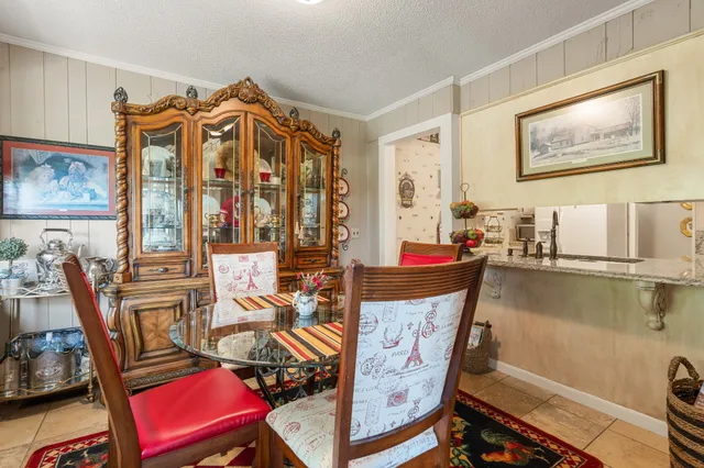 a bedroom with a bed mirror and a window