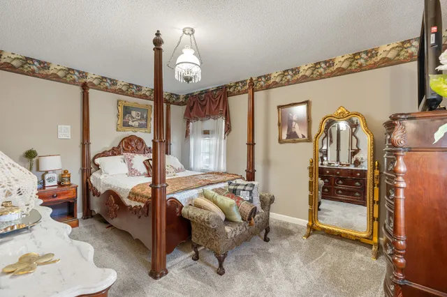 a bedroom with furniture and a fireplace