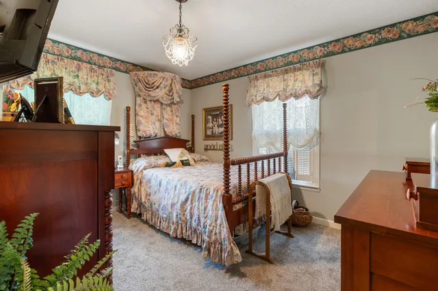 a bedroom with furniture and a potted plant