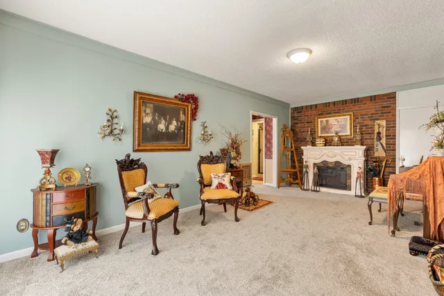 a bathroom with a toilet sink vanity granite and shower