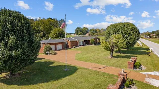 a view of a house with a yard and garage