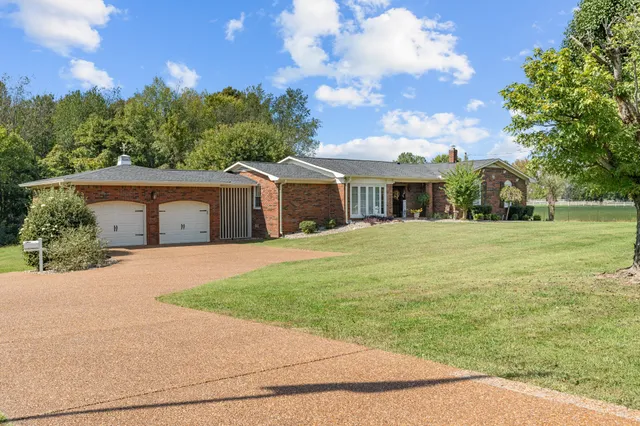 a front view of a building with potted plants