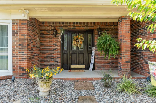 a view of a house with a yard and sitting area