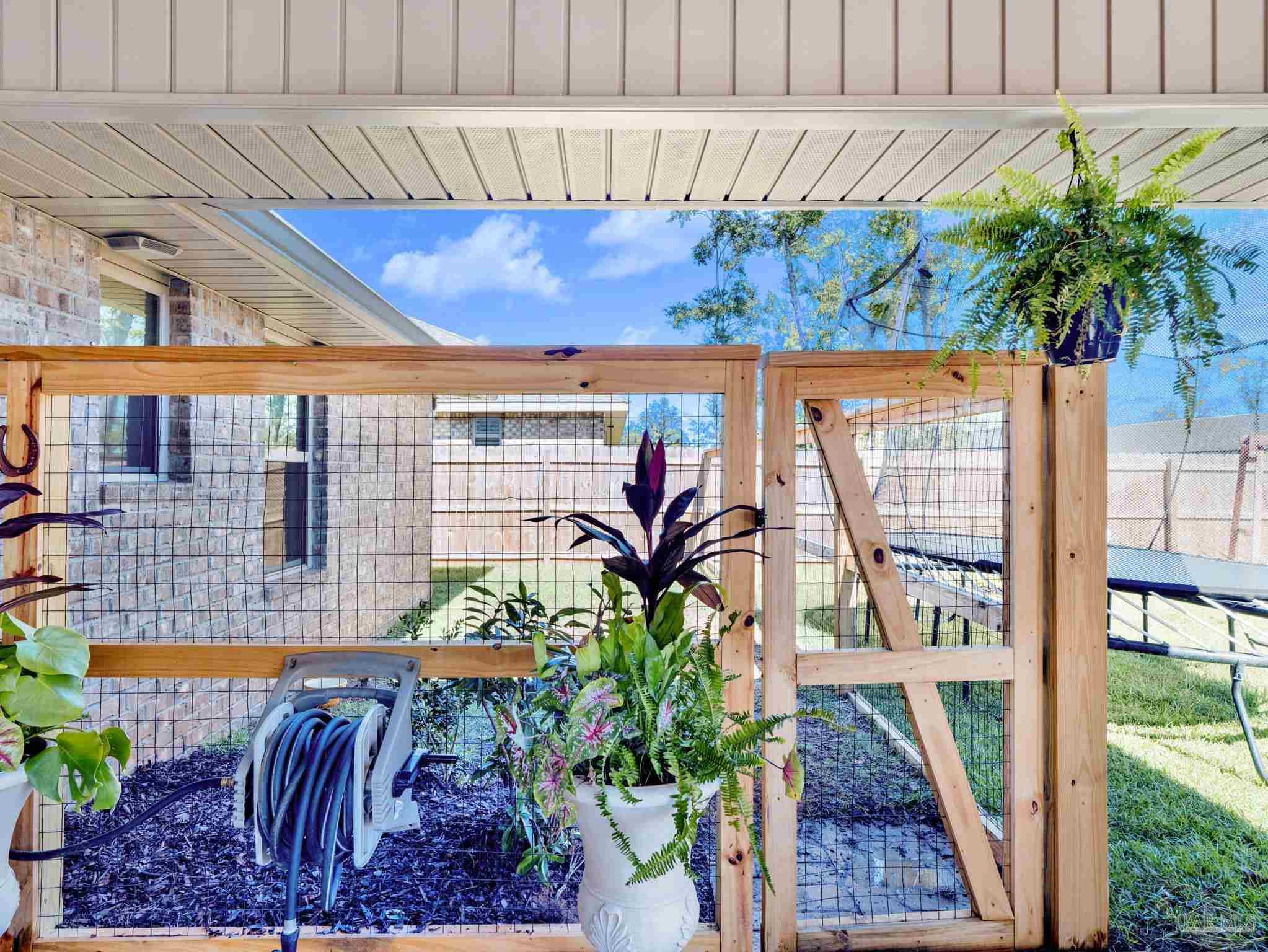 5956 Parsonage Circle Milton, FL 32570 - Photo 14 of 66 a view of entryway with flower plants