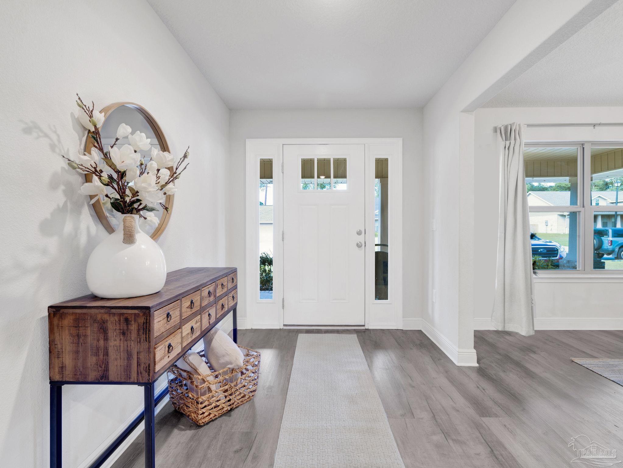 5956 Parsonage Circle Milton, FL 32570 - Photo 16 of 66 a view of a livingroom with furniture and wooden floor