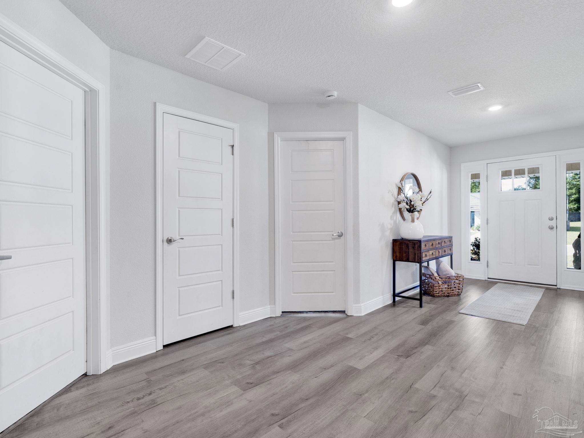 5956 Parsonage Circle Milton, FL 32570 - Photo 17 of 66 a view of a room with wooden floor and a chair
