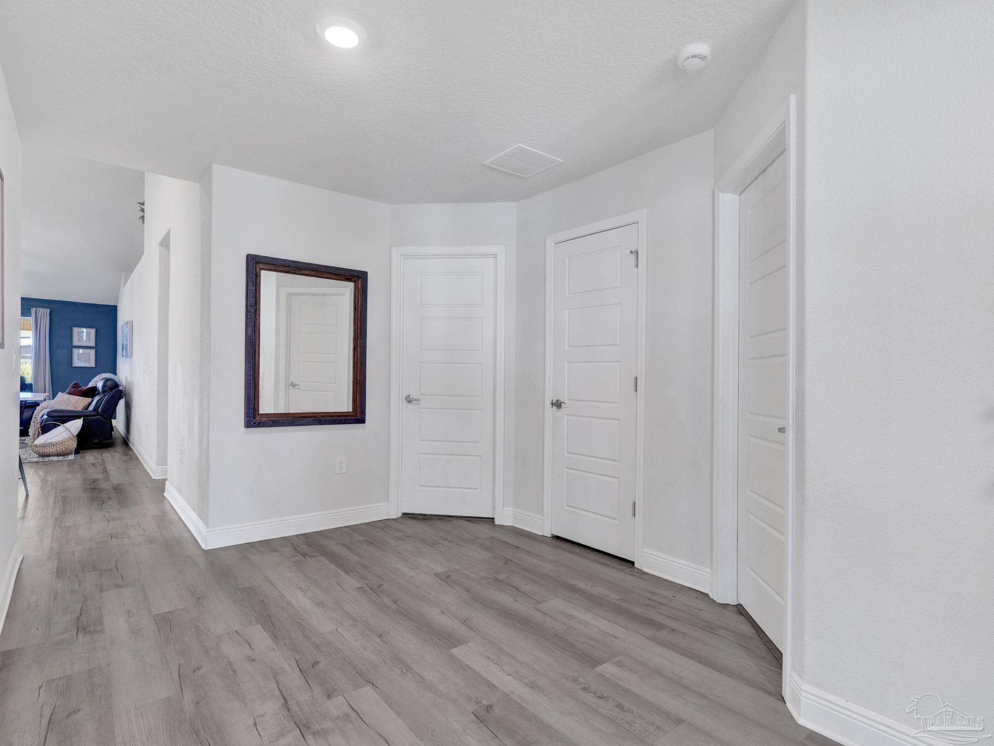 5956 Parsonage Circle Milton, FL 32570 - Photo 18 of 66 a view of livingroom with hardwood floor and hallway