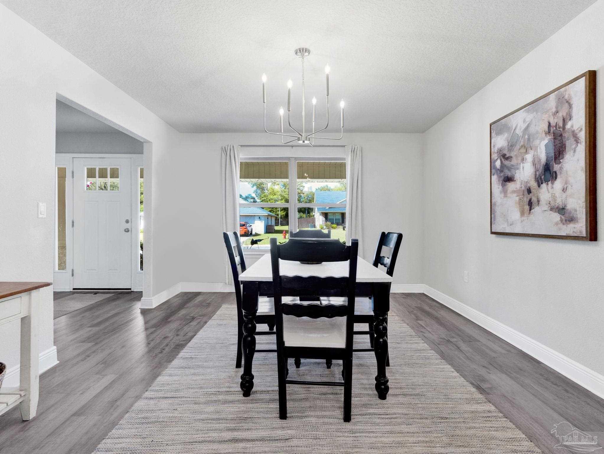 5956 Parsonage Circle Milton, FL 32570 - Photo 19 of 66 a view of a dining room with furniture window and wooden floor