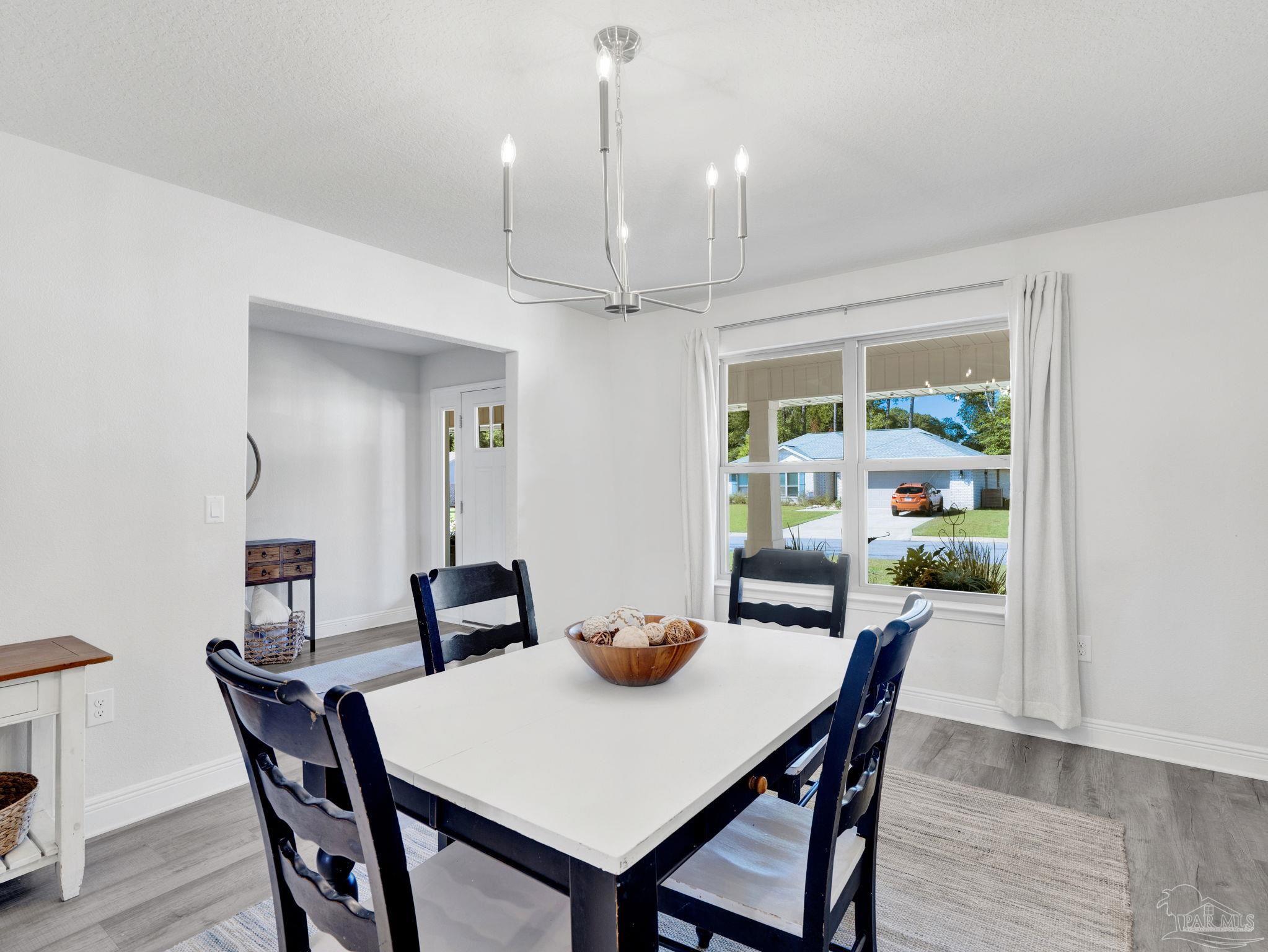 5956 Parsonage Circle Milton, FL 32570 - Photo 21 of 66 a view of a dining room with furniture window and wooden floor