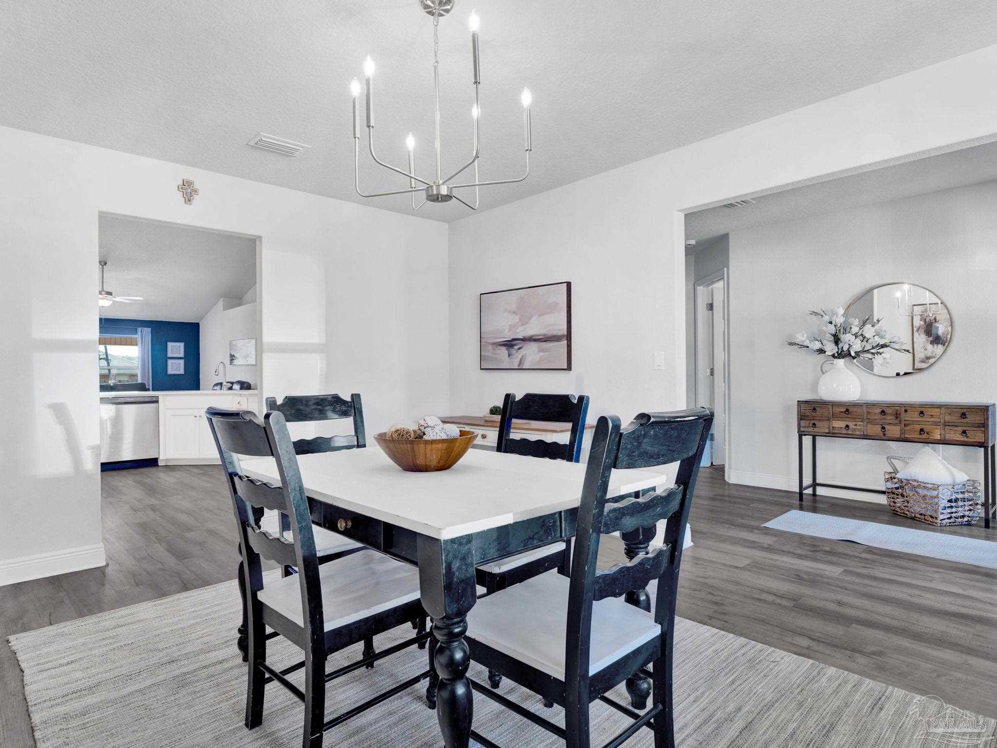 5956 Parsonage Circle Milton, FL 32570 - Photo 22 of 66 a view of a dining room with furniture and wooden floor